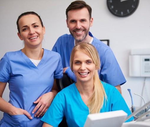 a dental team smiling at the camera