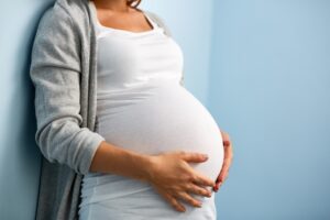 Pregnant woman holding her stomach 